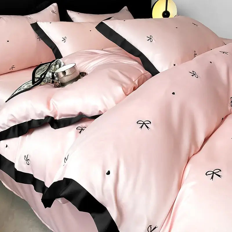 Luxury pink satin bedding sets with black bow and heart embroidery in decorbites ice silk for elegant bedroom decor