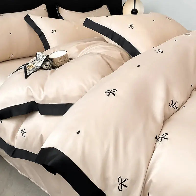 Luxury beige satin bedding sets with black embroidered bows and trim made from decorbites ice silk for elegant bedroom decor