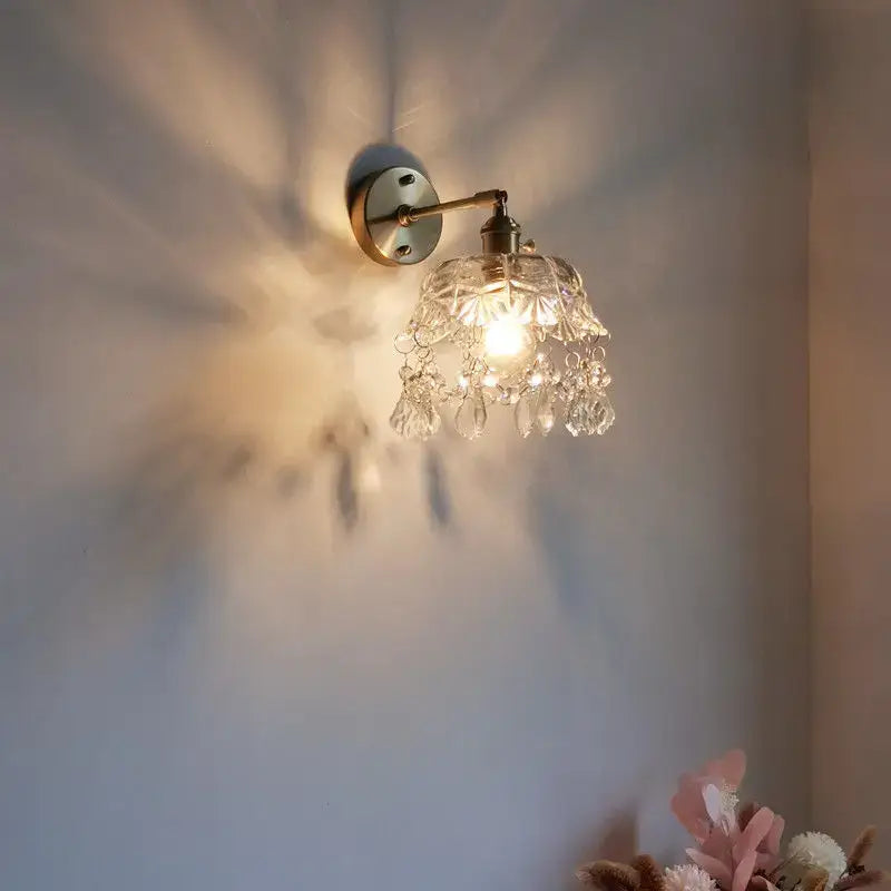 Antique brass luxury crystal copper led wall sconce with faceted crystal shade and teardrop crystals for bedroom lighting