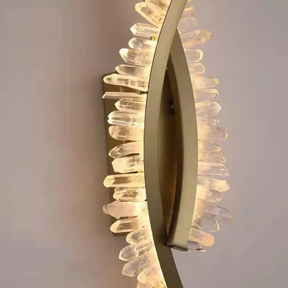 Luxury crystal gold metal wall sconce with curved frame and faceted quartz crystals for warm living room decorbites glow