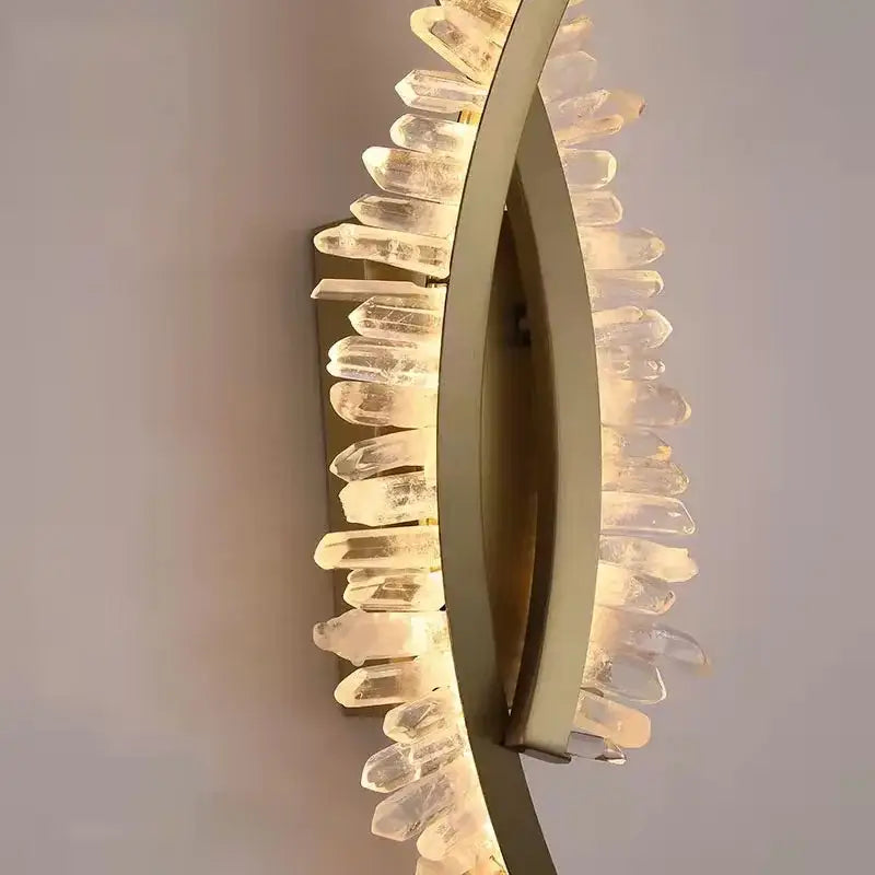 Luxury crystal gold metal wall sconce with curved frame and faceted quartz crystals for warm living room decorbites glow