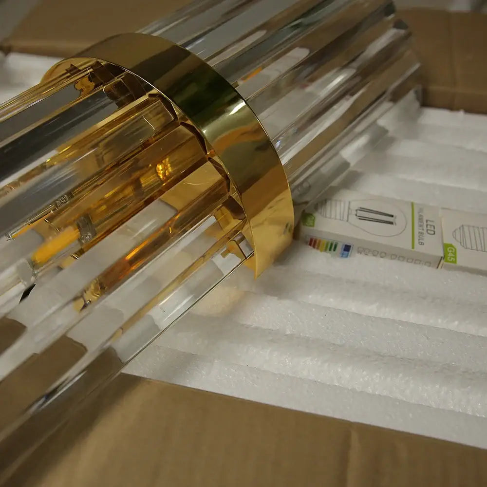 Luxury crystal golden wall lamp with clear acrylic cylindrical design and vertical rods for modern bedroom decorbites crystal golden