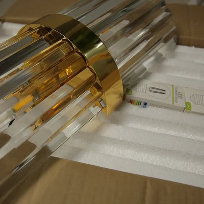 Luxury crystal golden wall lamp with clear acrylic cylindrical design and vertical rods for modern bedroom decorbites crystal golden