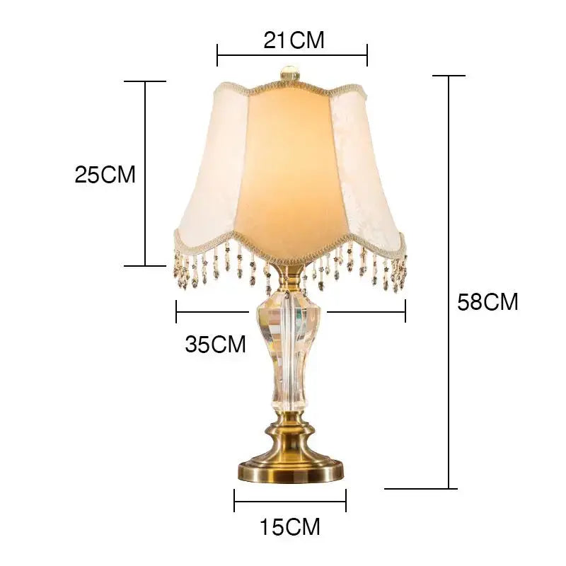 Elegant luxury crystal table lamp with brass base and cream fabric lampshade featuring dangling crystals decorbites crystal table