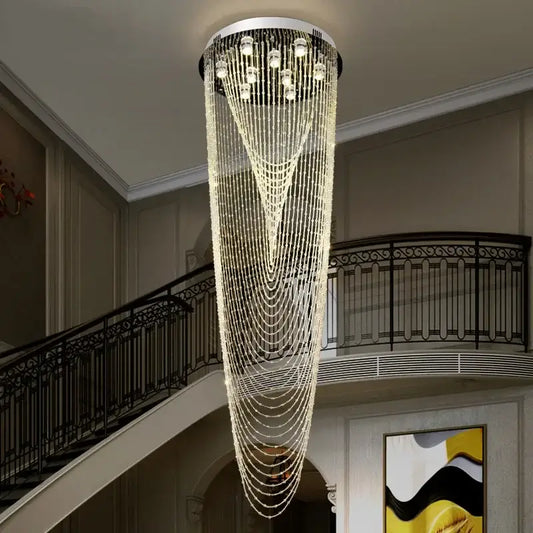 A luxury crystal tassel stair chandelier with cascading clear beads and lights on a sleek white circular frame