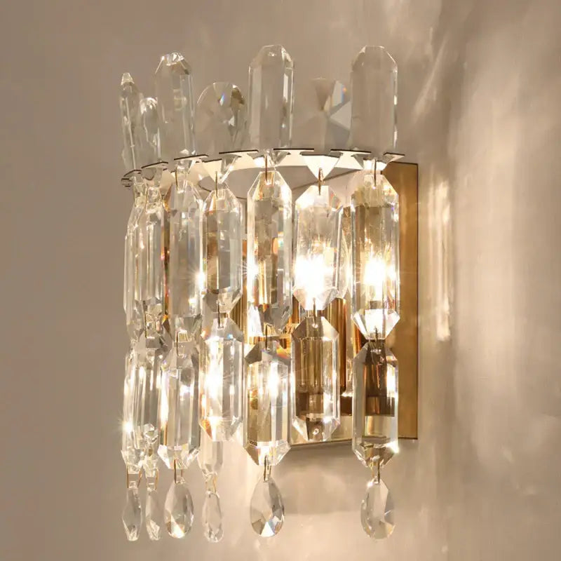 Luxury crystal wall lamp with gold-toned metal frame and cascading clear glass prisms for elegant decorbites crystal wall decorbites crystal wall lamp