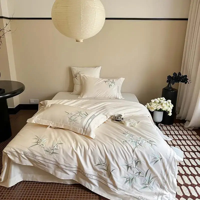 Cream-colored satin bedding set with gray bamboo embroidery and black piping in 1000tc egyptian cotton luxury design