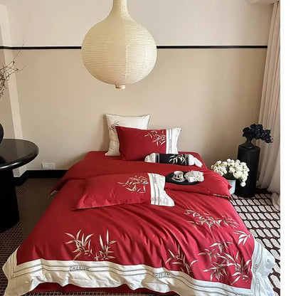 Red satin duvet cover set with embroidered bamboo motifs and white trim in a 1000tc egyptian cotton bedding set
