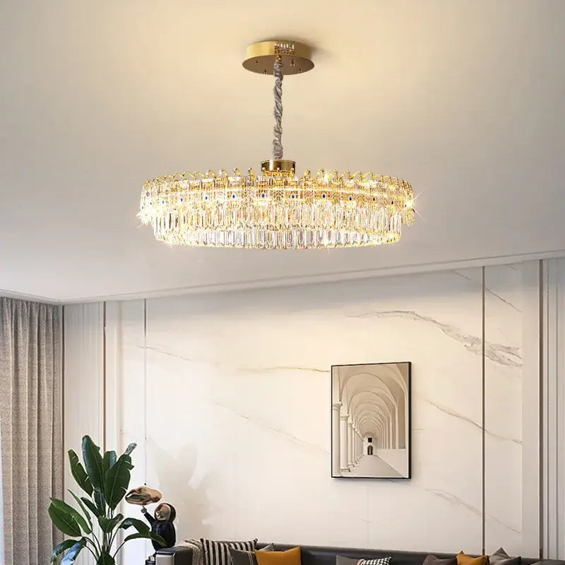 Luxury gold and blue crystal ceiling chandelier with gold-toned circular frame and cascading decorbites crystal prisms