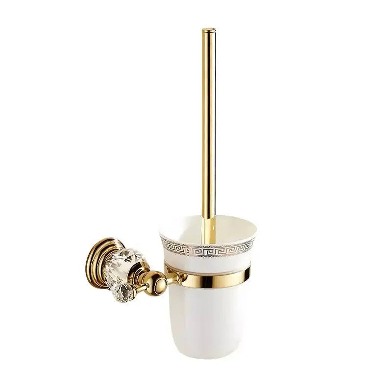 White ceramic toilet brush holder with gold greek key accents and matching gold-handled brush in luxury bath hardware set
