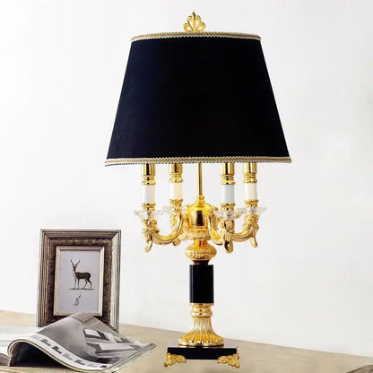 Elegant gold-toned table lamp with black crystal bedroom design featuring velvet shade and crystal accents by decorbites