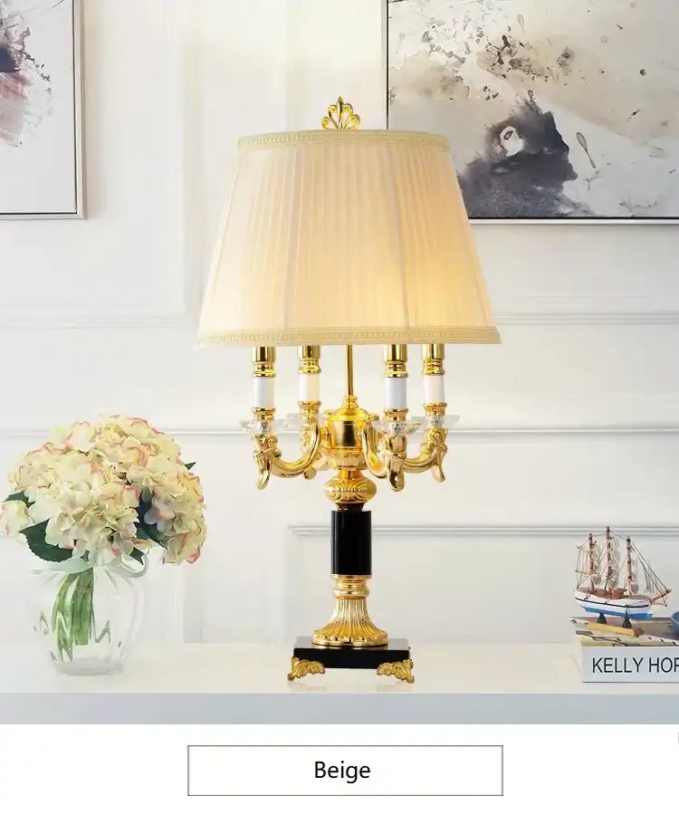 Elegant gold-toned table lamp with black crystal accents and beige pleated shade for black crystal bedroom decor by decorbites