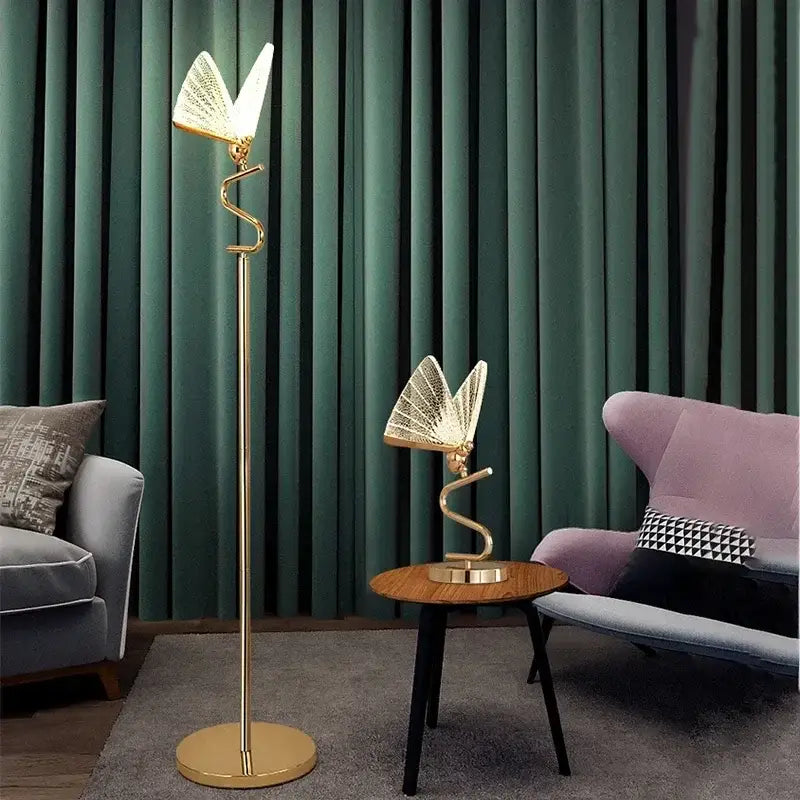 Gold-finished decorbites butterfly floor lamp with slender curved stem and illuminated winged head for living room lighting