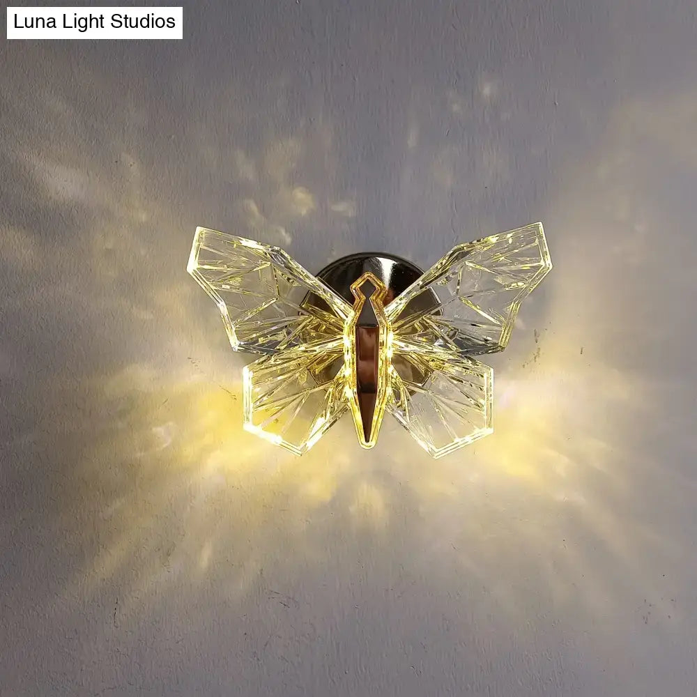 Luxury gold butterfly wall lamp with crystal faceted wings and gold-toned body for elegant bedroom lighting