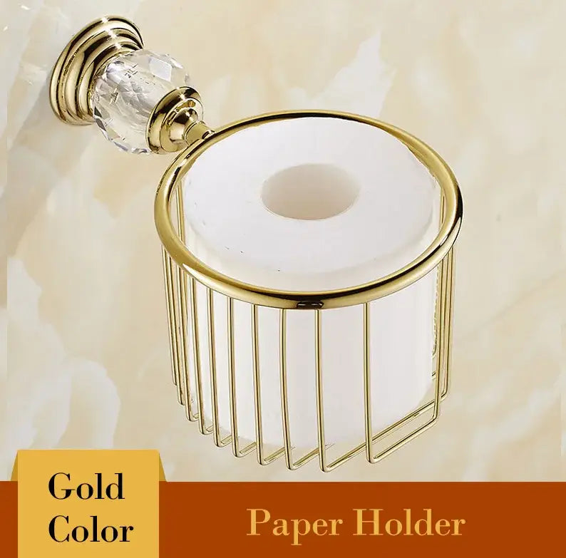 Gold-colored metal toilet paper holder with crystal accent and vertical wire mesh design from luxury crystal bathroom set decorbites brass