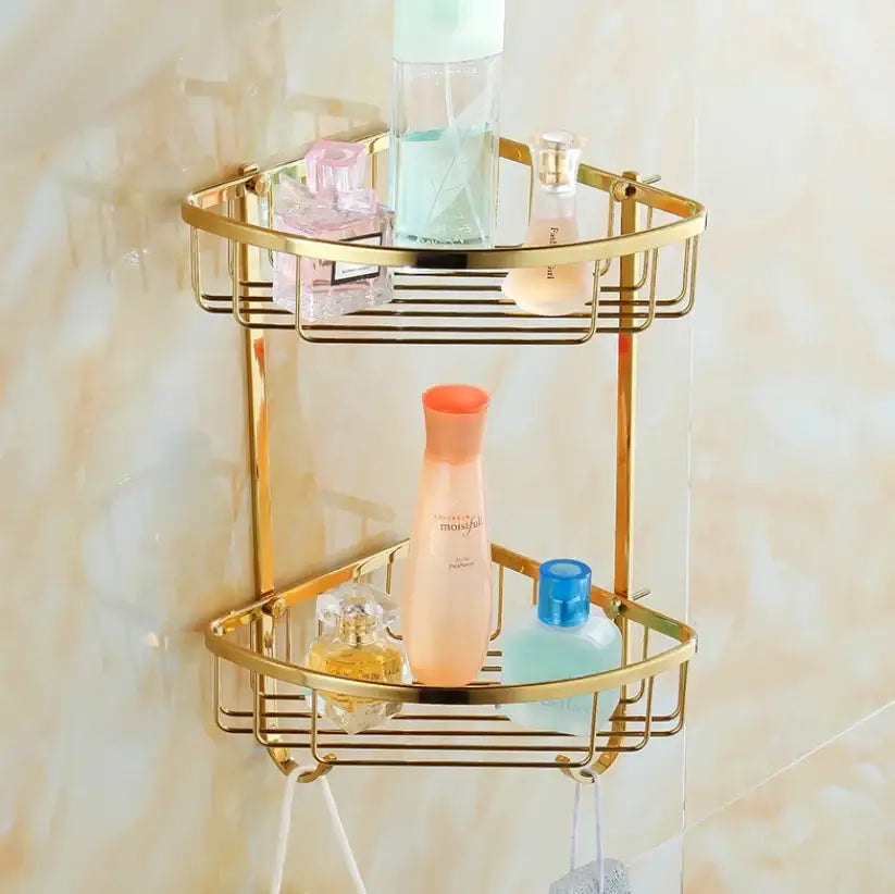 Gold-colored two-tiered corner bathroom shelf with wire mesh design from decorbites brass crystal bathroom set