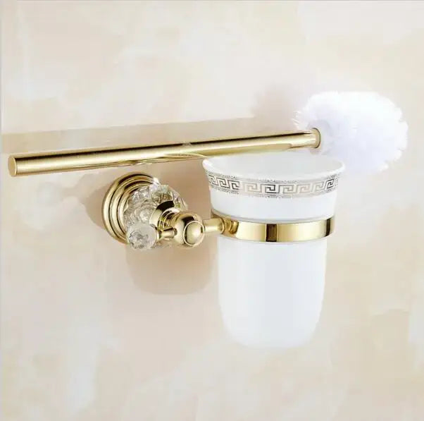 Gold-toned toilet brush holder with frosted ceramic cup featuring greek key pattern and crystal accents from decorbites brass bathroom set
