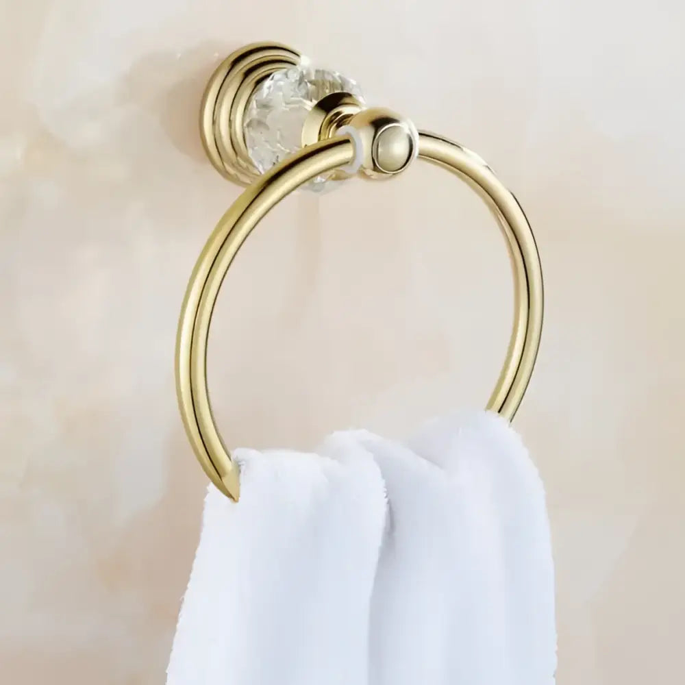 Luxury gold towel ring with clear crystal accent from decorbites brass crystal bathroom set holding white towel