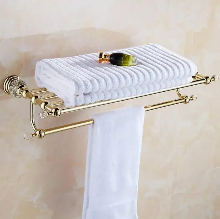 Luxury gold and crystal bathroom set towel rack with dual tiers holding white textured towel decorbites brass design