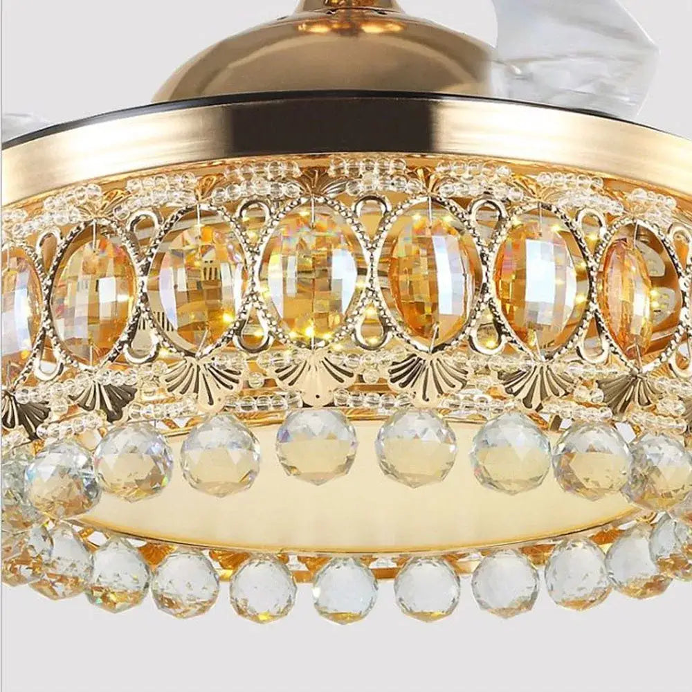 Luxury gold crystal ceiling fan light with gold-toned crystal chandelier, oval amber crystals, and clear faceted beads
