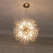 A luxury gold-toned decorbites dandelion chandelier with intricate crystal branches and multiple illuminated bulbs for living room light