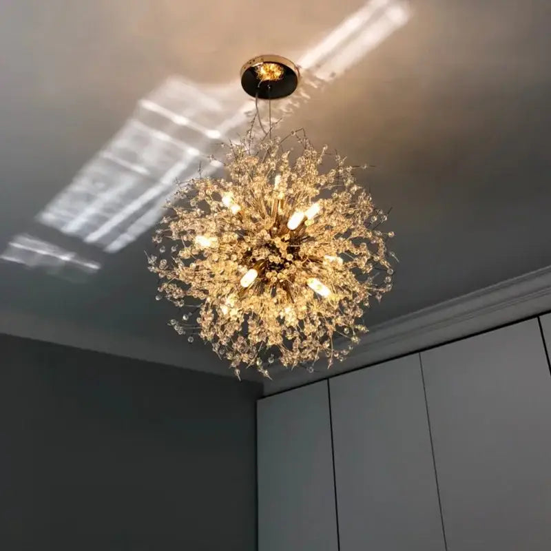 A golden decorbites dandelion chandelier featuring crystal drapes and a central brass fixture for living room lighting