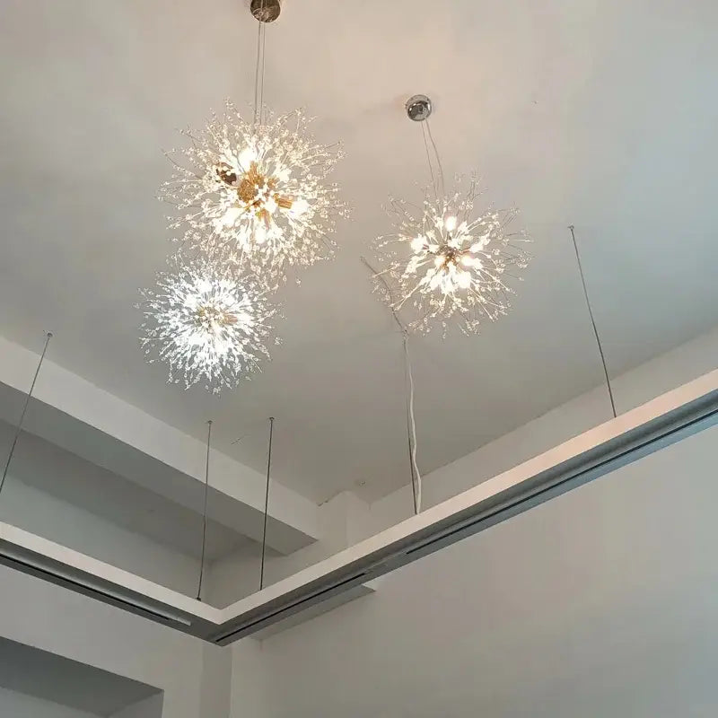 Three elegant gold-toned decorbites dandelion chandelier lights with clear crystal filaments for living room decor