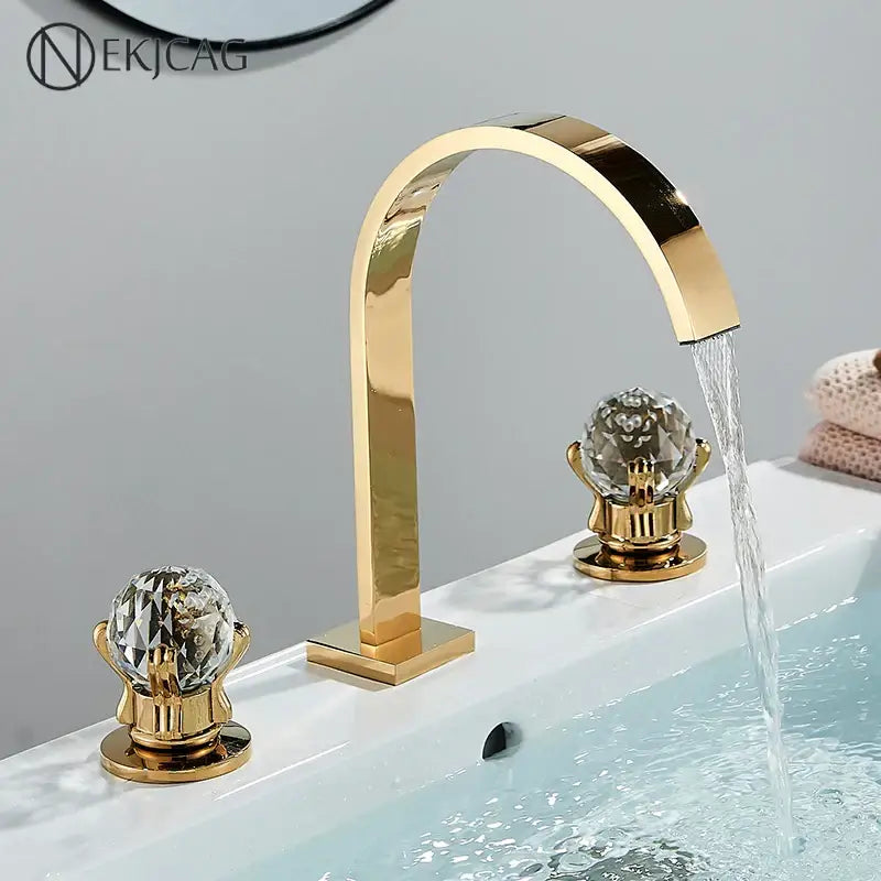 Luxury gold crystal handle basin faucet with decorbites crystal knob handles and a sleek arched mixer spout