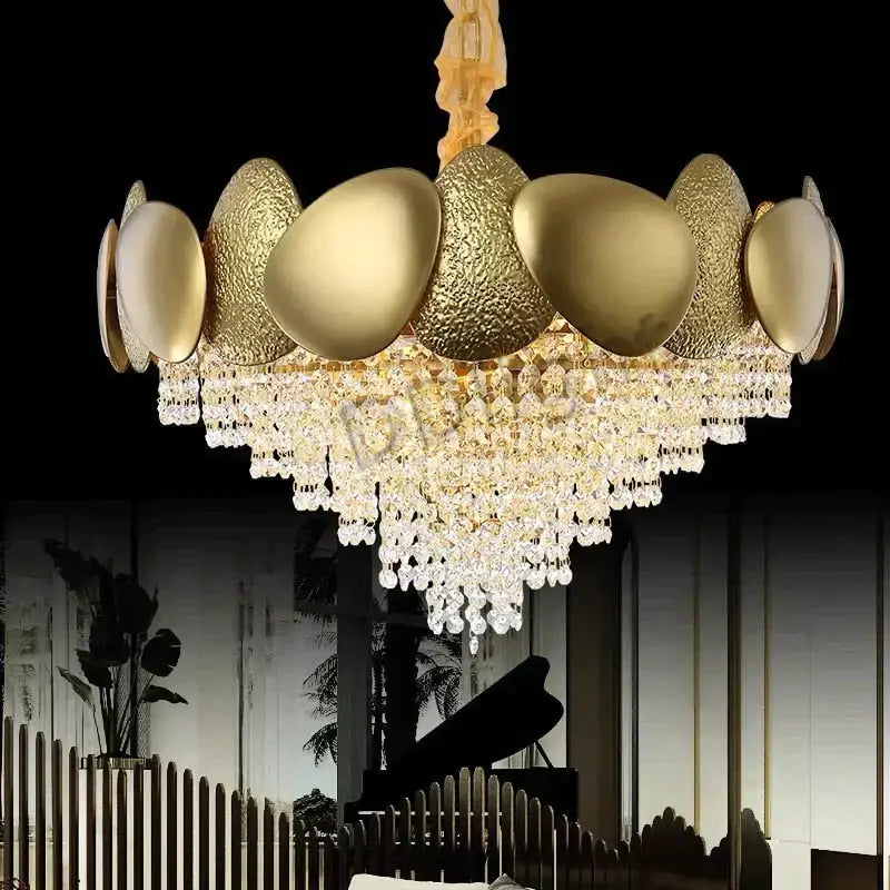 Golden egg-shaped led ceiling chandelier with textured metallic surfaces and cascading crystal tassels by decorbites lizzie
