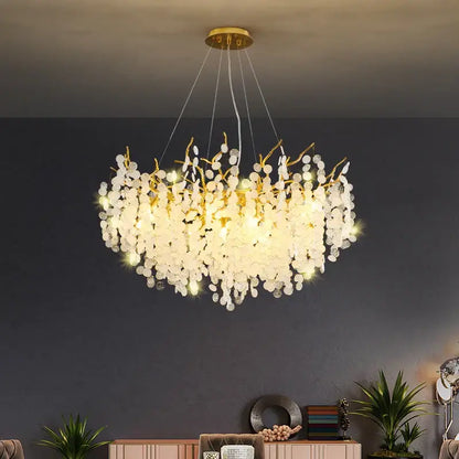 Elegant gold-toned decorbites crystal led chandelier with cascading white crystal petals for luxury dining room decor