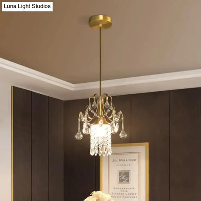 A gold-toned decorbites luxury single head pendant light with crystal teardrops and frosted glass shade for dining room