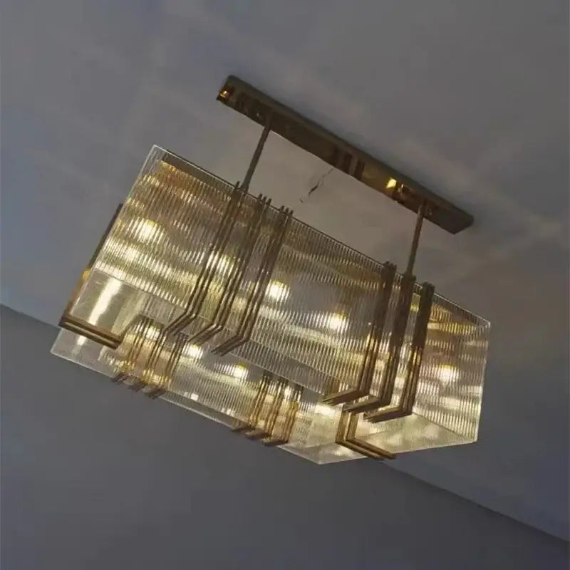 A luxury gold crystal rectangular pendant light with gold-toned metal and textured glass for dining room decorbites gold lustre decor