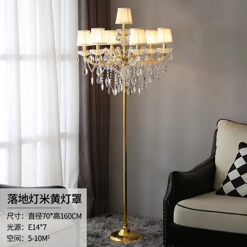 Luxury gold crystal table light with cream shades and dangling crystal droplets for elegant bedroom decor