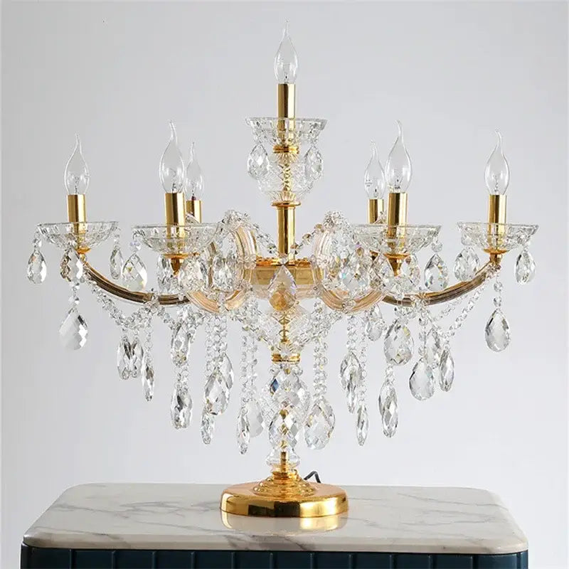 Luxury gold crystal table light with multiple arms and clear faceted crystals for elegant bedroom lighting