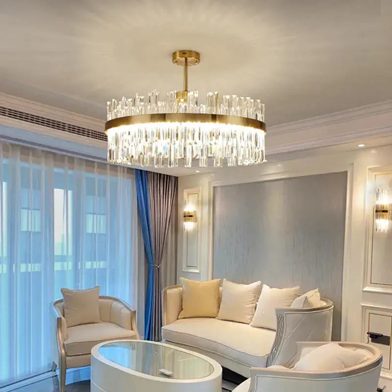 A luxury gold decorbites crystal chandelier with clear glass prisms designed for dining room use