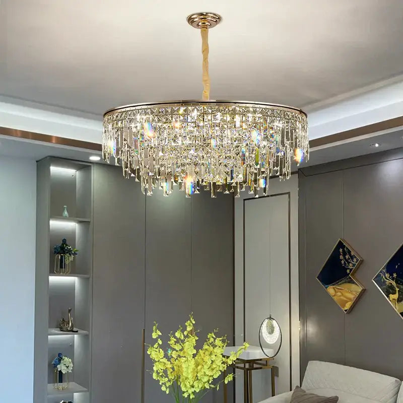 Luxury gold decorbites crystal led chandelier with clear prisms and a gold-toned frame for living room decor