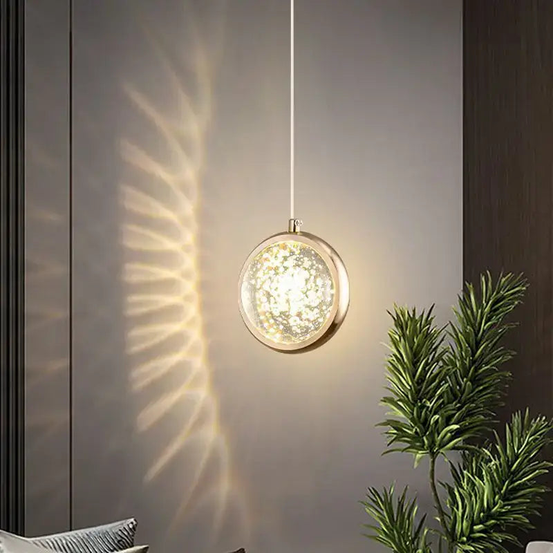 Luxury gold deer crystal ball chandelier pendant light with gold metallic frame and illuminated glass globe casting shadows