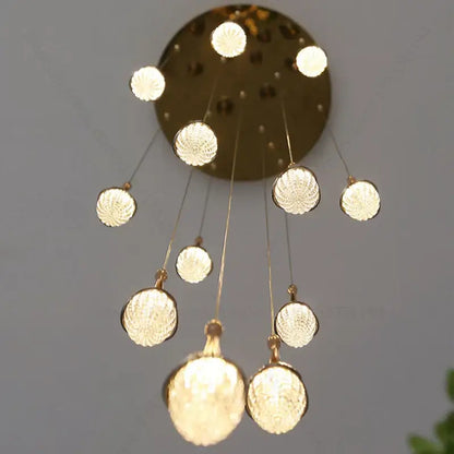 Luxury gold led staircase chandelier with gold-toned spherical textured glass globes by decorbites gold led decor