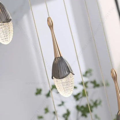 Luxury gold led staircase chandelier with a gold-toned stem and dark gray faceted glass shade by decorbites gold led