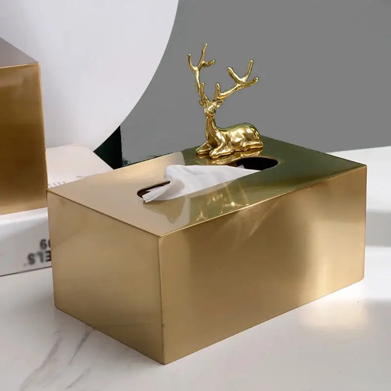 Luxury gold metal tissue box with a polished finish and ornamental golden deer figurine for living room storage