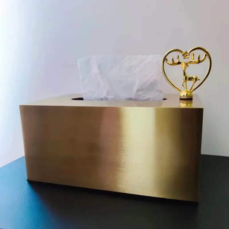 Luxury gold metal tissue box with polished finish and ornamental golden deer figurine in a heart-shaped frame