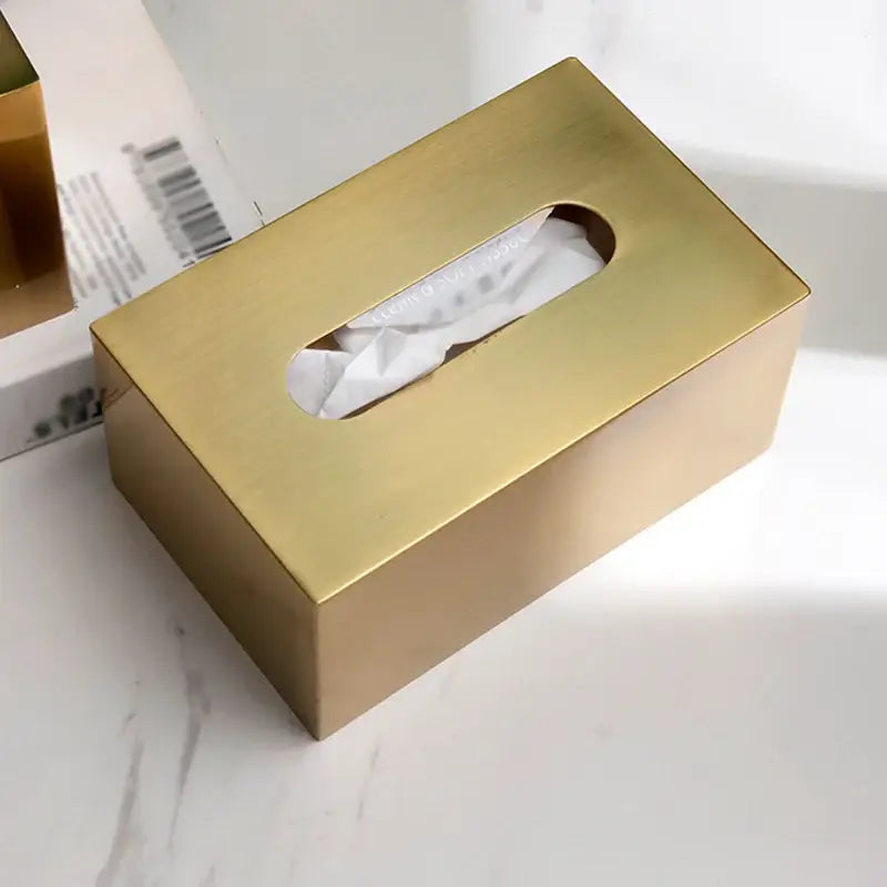 Luxury gold metal tissue box with brushed finish and oval cutout featuring deer figurine for living room storage