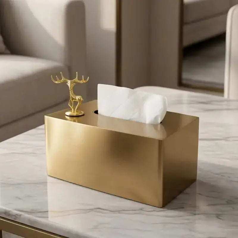 Luxury gold metal rectangular tissue box with a small golden deer figurine on top for living room storage
