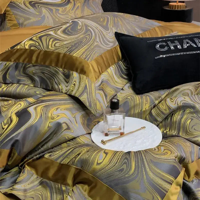 Luxury gold and gray marbled satin bedding set featuring black chanel pillow in decorbites brocade satin jacquard material