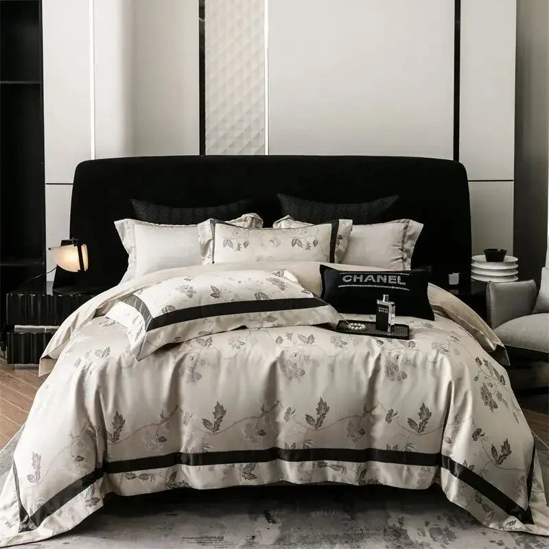 Cream-colored satin bedding set with gray botanical embroidery and black piping in decorbites brocade satin jacquard design