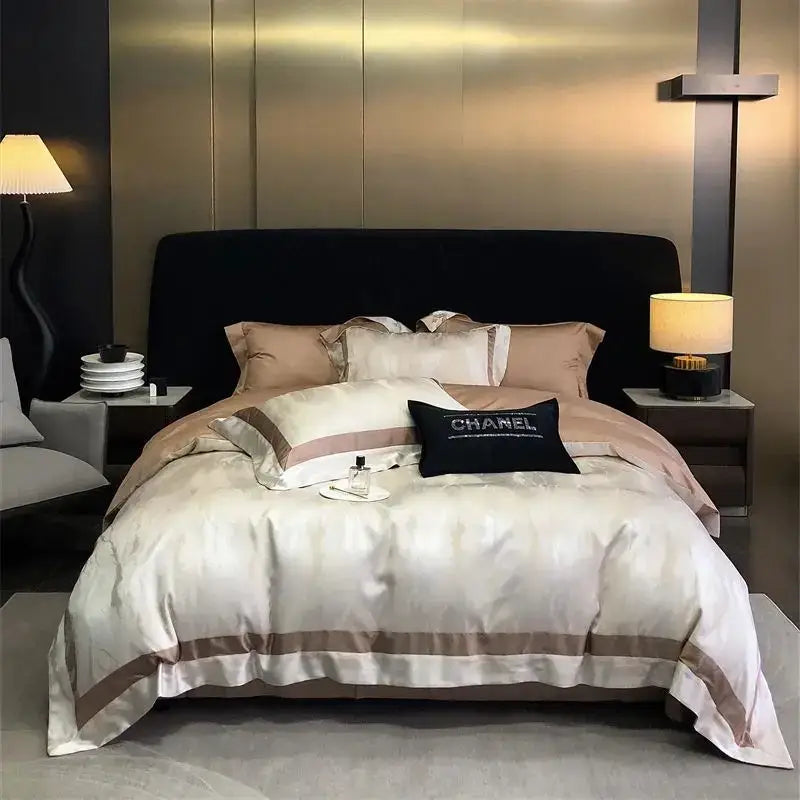 Cream-colored brocade satin jacquard bedding set with taupe piping and black Chanel logo pillow by decorbites