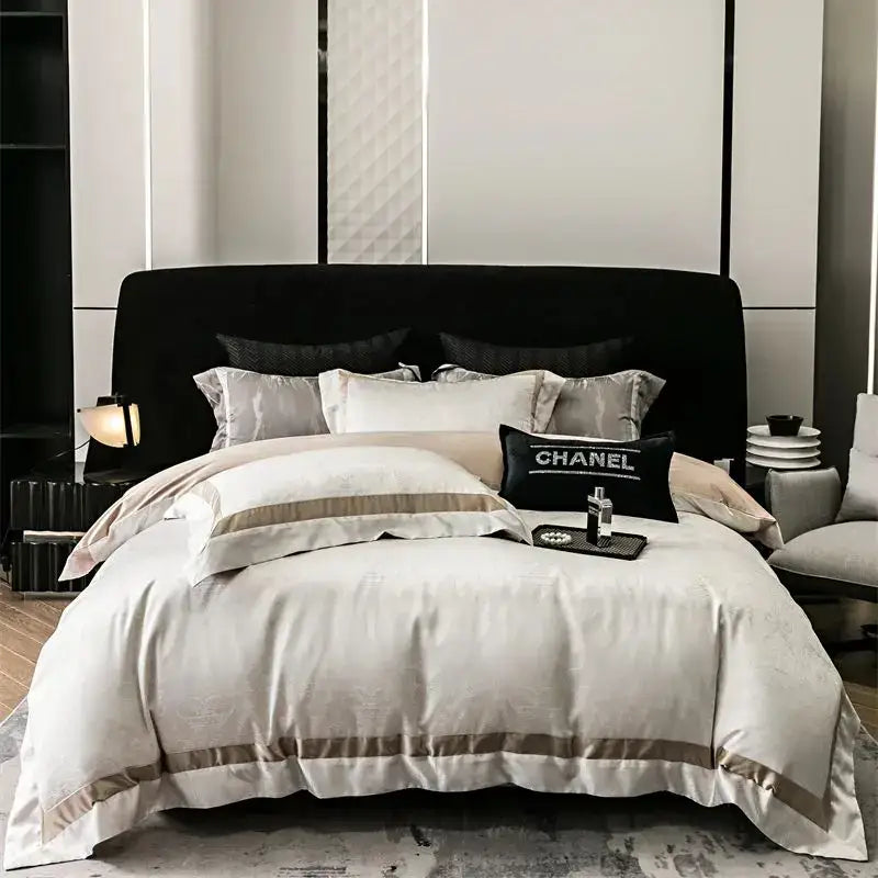 Cream-colored satin bedding set with taupe piping and black chanel pillow in luxury decorbites brocade satin jacquard style