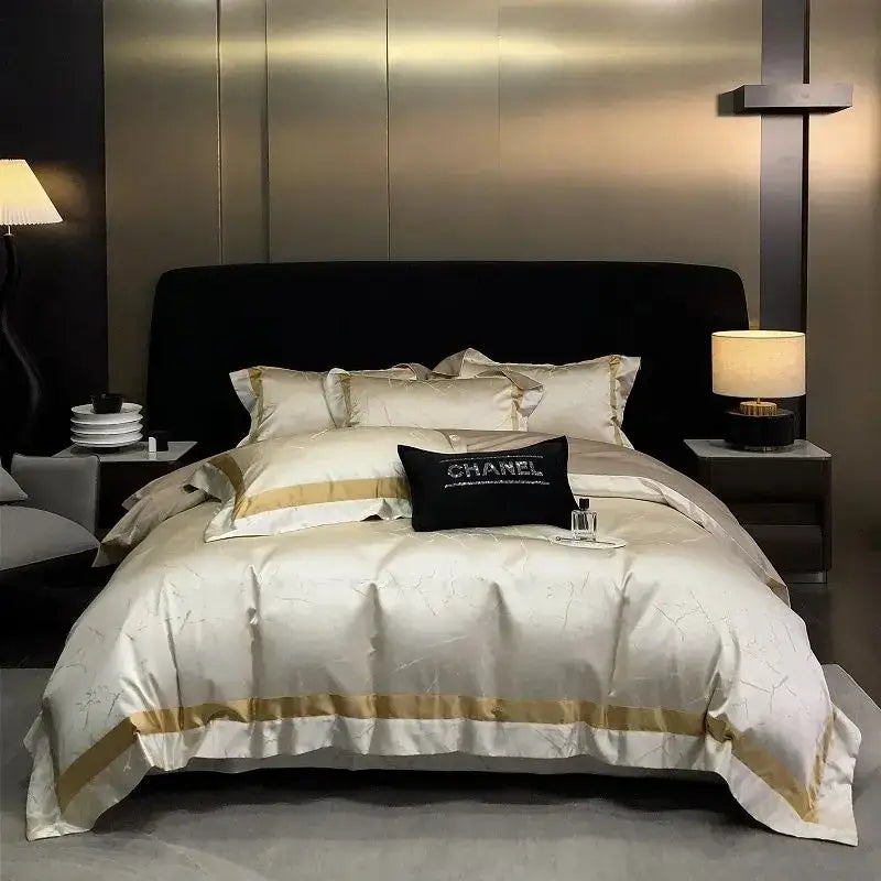 Cream-colored brocade satin jacquard bedding set with gold trim and a black Chanel pillow for luxury decorbites decor