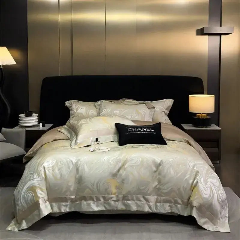 Cream-colored satin duvet cover with gold-toned brocade satin jacquard patterns and a black chanel pillow from decorbites bedding set