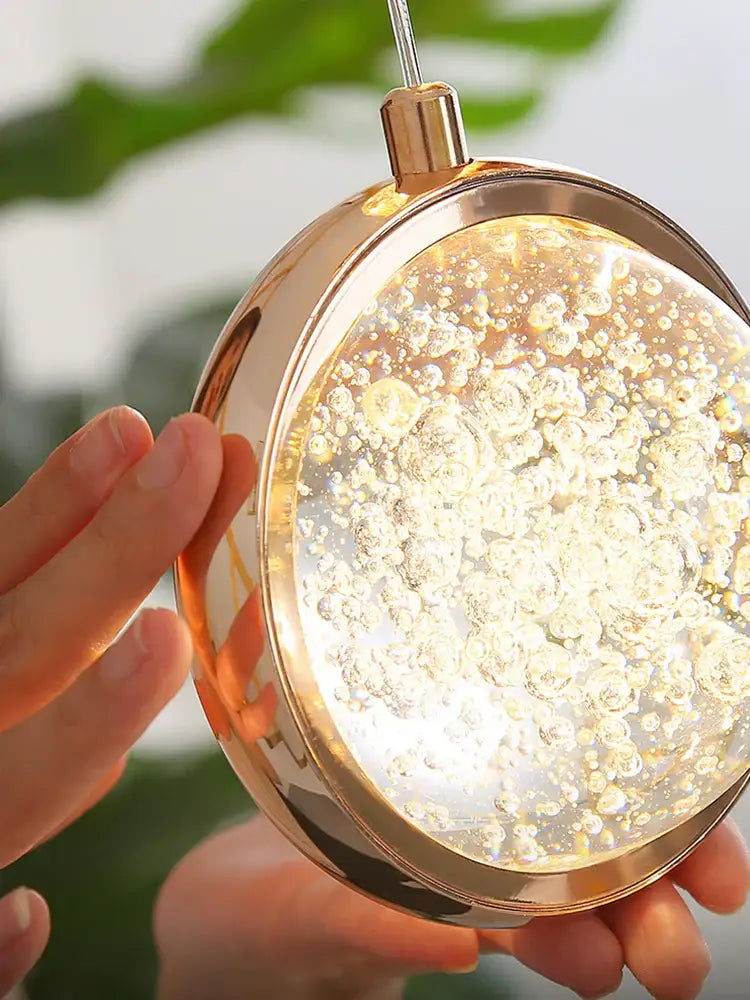 Luxury golden decorbites crystal ball led rotating stair chandelier with a round gold-toned pendant and glowing bubbles